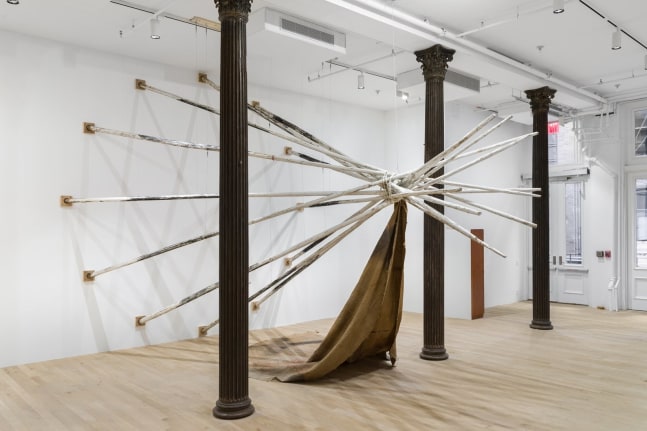 duane linklater. dislodgevanishskinground, 2019. 12 tipi poles, steel cable, white paint, charcoal, rope, digital print on linen, black tea, blueberry extract, sumac, charcoal