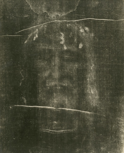 Giuseppe ENRIE (Italian, 1886-1961) Detail of the Shroud of Turin, 1931 Gelatin silver print from a glass negative 29.5 x 23.4 cm mounted on 41.9 x 31.5 cm paper, ruled Blindstamped “FOT. CAV. G. ENRIE / RIPRODUZIONE INTERDETTA”. Printed “SANTO VOLTO DEL DIVIN REDENTORE / (PARTICOLARE DELLA S. SINDONE) / CAV. G. ENRIE FOTOGRAFÒ / RIPRODUZIONE INTERDETTA / ADORAMUS TE, CHRISTE, ET BENEDICIMUS TIBI / IL PRESIDENTE DELLA COMMISSIONE ESECUTIVA / TORINO 3 – 24 MAGGIO 1931” on mount with ecclesiastical authentication in facsimile signatures. Luigi Gay Caroleria label on mount verso.
