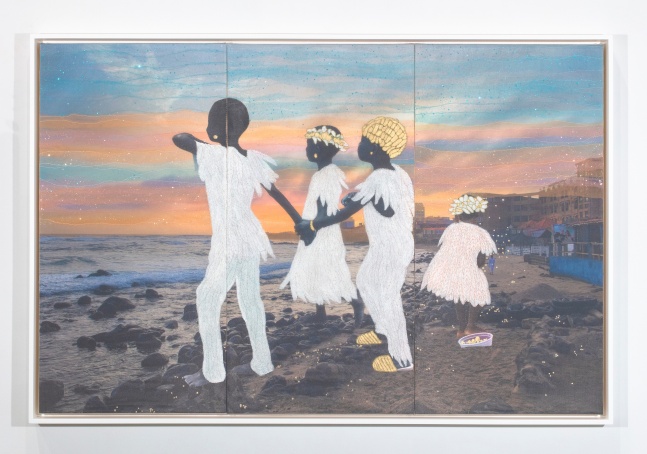 Four children in white clothes standing on beach, looking into the sunrise over the water. Three holding hands and the third with back towards viewer.