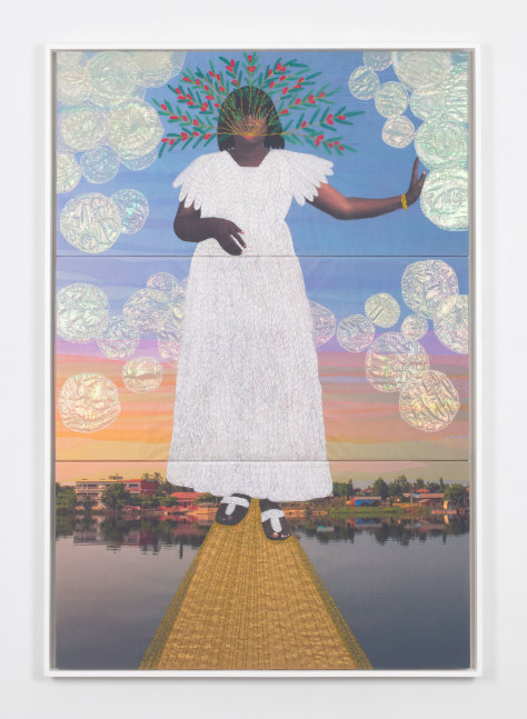 framed embroidered artwork of a woman wearing a white dress holding out one hand to the side and appearing to float on a body of water