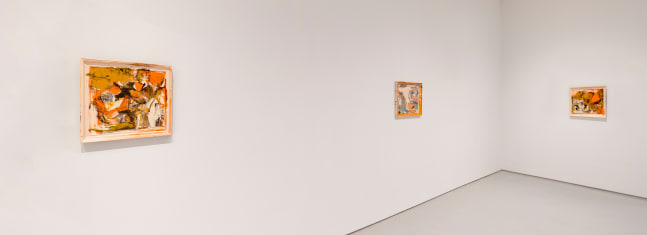 Three predominantly orange abstract paintings featured on two white adjacent walls.