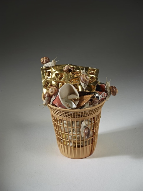 ceramic basket filled with cups and trash with snails