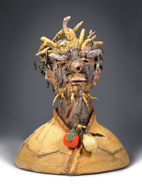 ceramic bust sculpture of a man with tree bark, branches and roots for skin