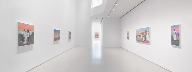 2 sets of three colorful artworks on opposing walls in a white room with an atrium