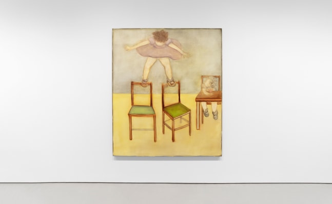 installation view of a large painting of a girl balancing on the backs of two chairs while another girl sits at a table nearby