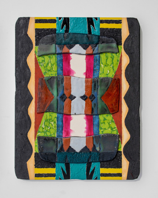 Black green blue yellow red and pink symmetrical geometric clay tablet.