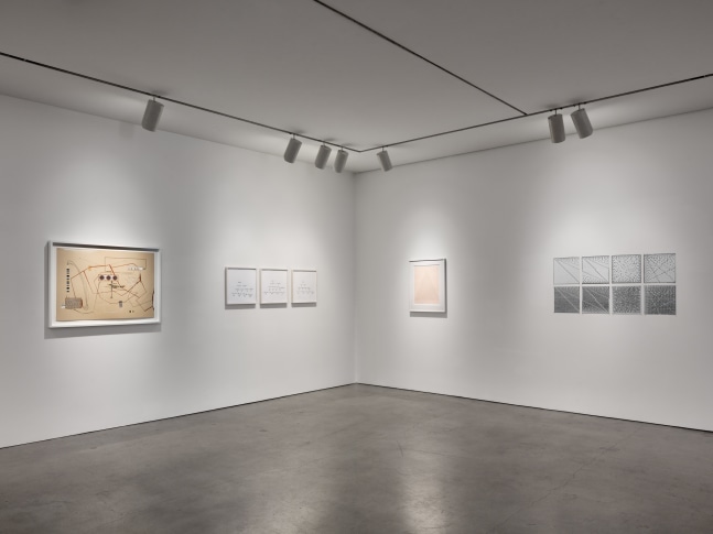 Installation view of &quot;Schema World as Diagram&quot; featuring four artworks on gray walls.