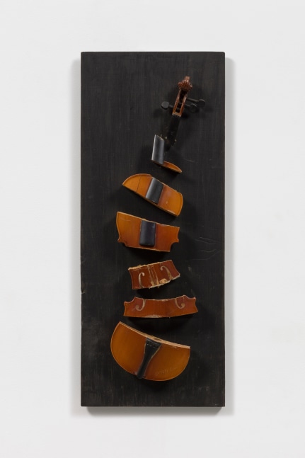 Violin sliced in seven parts on a dark wood panel