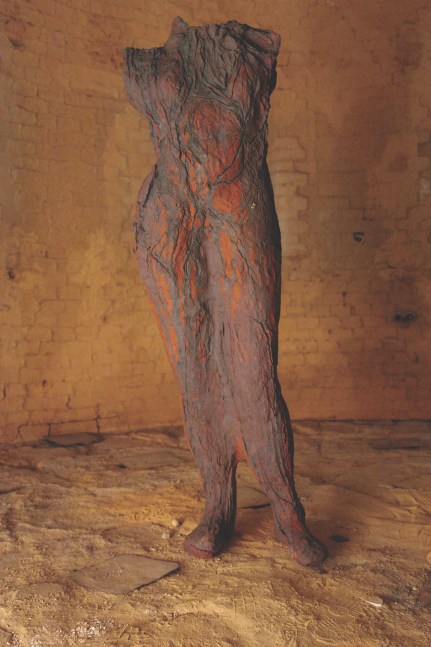Textured earthenware sculpture of human body with burnt orange hues by Michele Oka Doner.