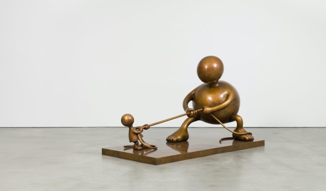Bronze sculptures depicting two rotund figures playing tug of war by Tom Otterness.