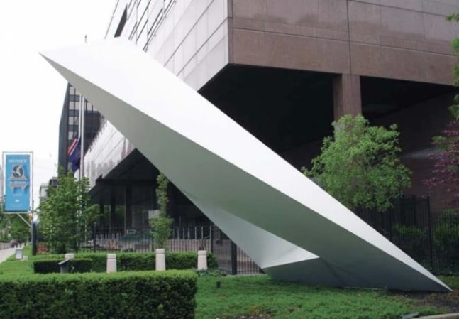 Photo of an abstract triangular white sculpture by Beverly Pepper