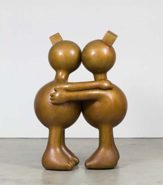 Two large bronze and rotund sculptures kissing by Tom Otterness.