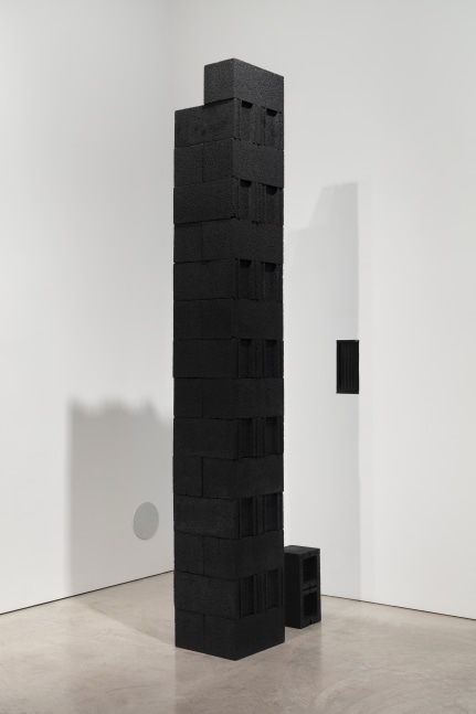 Photo of a stack of black cinderblocks