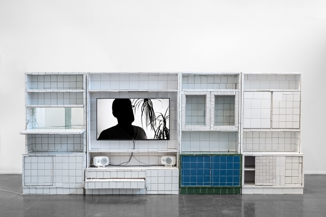 Matias Faldbakken EUROPE IS BALDING, 2016 ceramic tiles and tile adhesive on entertainment center, video monitor, video: 12 minutes and 23 seconds 71 x 16 x 165 in. (180.3 x 40.6 x 419.1 cm) Edition 2 (version 2) of 3, 1 AP