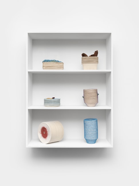 Veronica Ryan Holding Stacks, 2021 card containers, seed husks, cotton crochet, paper plates, avocado trays, hydrocal, plastic net, hairnet, fishing line, cotton, mango stones