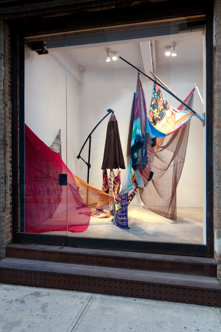 Eric N. Mack Landlord, 2021 umbrella, wood flagpoles, metal brackets, fabric collage, thread dimensions variable
