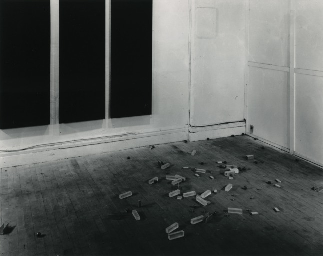 Carl Andre Scatter Piece, New York, 1966 33 ball bearings, 13 pulley discs, 9 pieces aluminum channel, 14 plexiglas rectangular solids, 7 aluminum ingots site-specific ball bearings: 1 3/8 in. (3.5 cm) ea.; pulley discs: 15/16 in. (2.4 cm) ea.; aluminum channel: 1 3/8 x 1 3/8 x 1 3/8 in. (3.5 x 3.5 x 3.5 cm) ea.; plexiglas pieces: 1 1/4 x 1 1/4 x 4 3/4 in. (3.2 x 3.2 x 12.1 cm) ea. and one at 1 3/4 x 1 1/2 x 3/8 in. (4.4 x 3.8 x .09 cm); aluminum ingots: 1 x 2 1/4 in. (2.5 x 5.7 cm) ea.