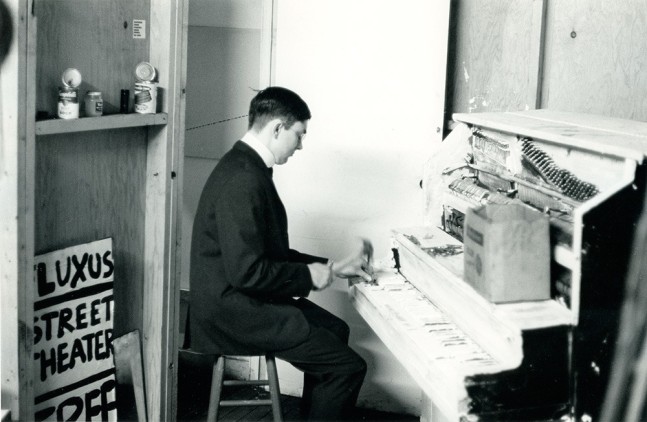 Peter Moore "George Maciunas performing his 'Piano Piece No. 13' Fluxhall, 359 Canal Street, NY" May 9, 1964 gelatin silver print 8 x 10 in.