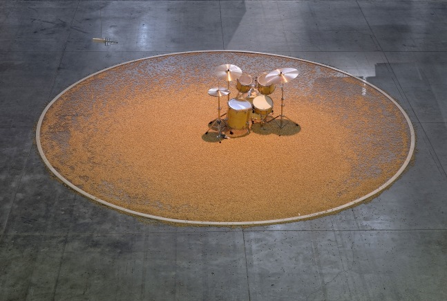 Céleste Boursier-Mougenot aura, La Sucrière - La 13ème Biennale de Lyon 2015 curated by Ralph Rugoff, maple acoustic drum set, electromagnetic radiation detector, DMX relay pack, mac mini, cherry pits, drum set installed within a 7m diameter (23 foot diameter) circle demarcated by a wooden ring. Photo by Blaise Adilon.