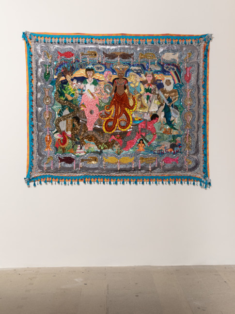 Installation view of artist Myrlande Constant's Vodou flag showcasing mermaids from Haitian Vodou hung up on a white wall.