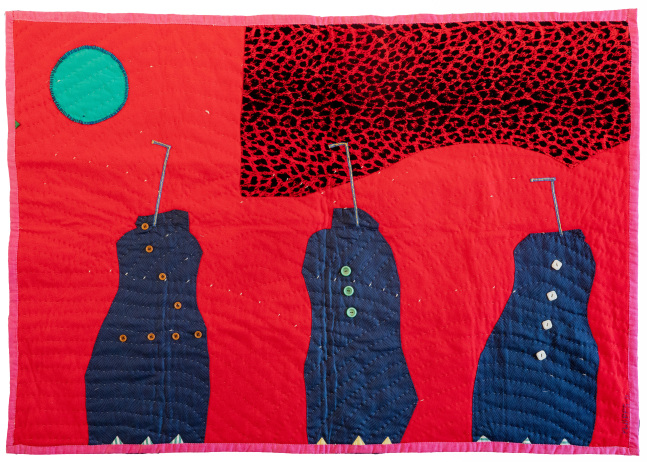 A red quilt depicting three blue jugs with straws
