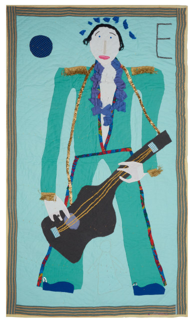 A narrow quilt of Elvis in a green suit playing a guitar