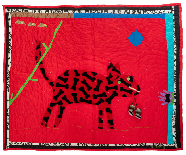 Quilt with a dog carrying a small pair of shoes