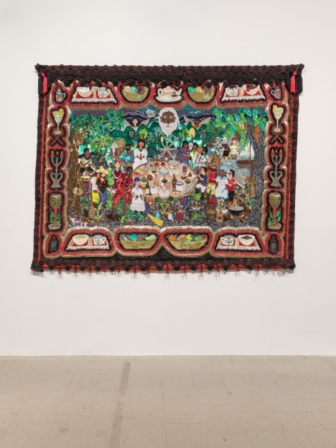 Installation view of artist Myrlande Constant's intricate Vodou flag hung up on a white wall.