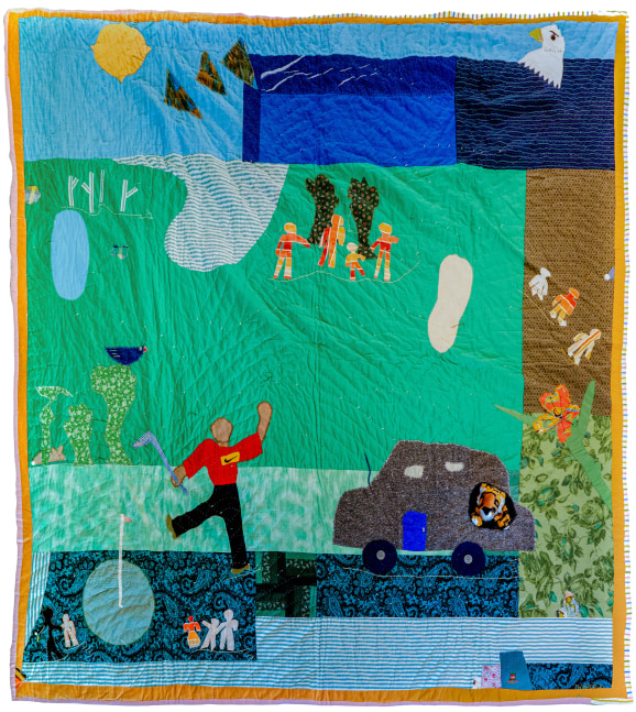 A quilt depicting a figure playing golf on a lawn with an audience