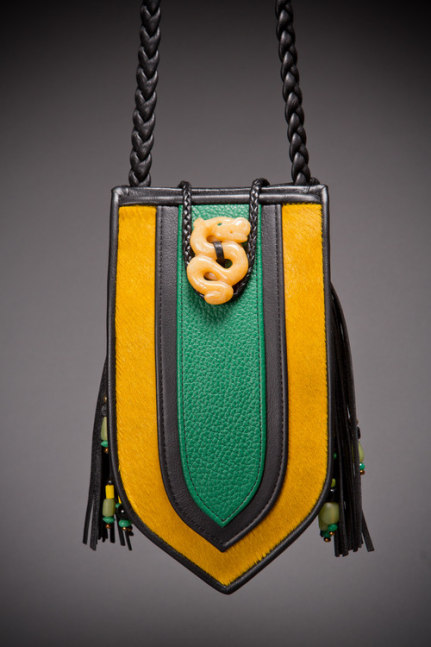 Shield Evening Purse
Hair-on calfskin, pebble green cowhide, cowhide binding and braided strap, yellow quartz hand-carved dragon enclosure, semi-precious beaded tassel and back.
5&amp;quot; x 9&amp;quot; x 3&amp;quot;
2019
