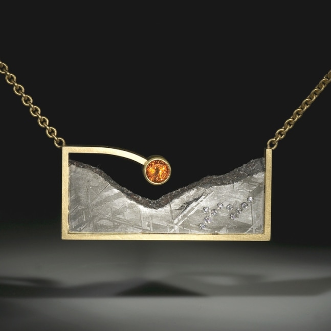 Dawn Necklace
Gibeon meteorite with diamonds and a 2.34 ct spessartite garnet, in an 18k gold satin finish frame with an 18k gold chain
2.38&amp;quot; x 1.08&amp;quot; x .5&amp;quot;