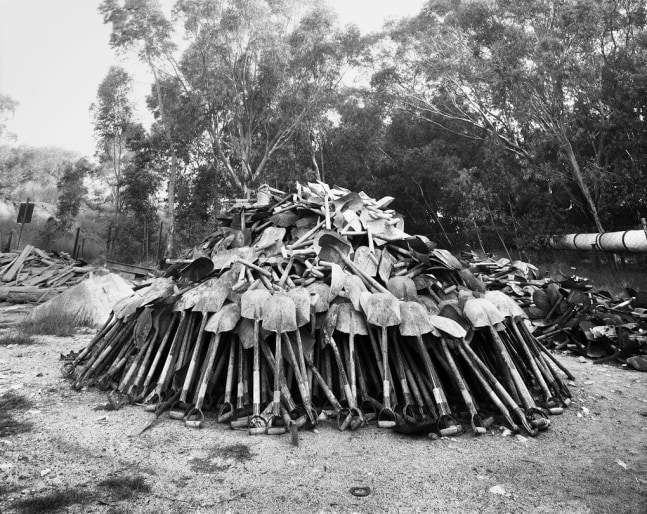 David Goldblatt
&amp;ldquo;Lashing&amp;rdquo; shovels retrieved from underground. Every grain of sand in the yellow tailings dumps that made the Witwatersrand landscape and every grain of gold that made its wealth, came from a rock off a black man&amp;rsquo;s shovel underground. Central Salvage Yard, Randfontein Estates, Randfontein, 1966 (4_0307), 1966
Silver gelatin print on fibre-based paper
Work: 43 x 54 cm / 16.9 x 21.3 in.
Frame: 61.6 x 71.5 cm / 24.5 x 28.1 in.
Edition 4 of 10

Enquire