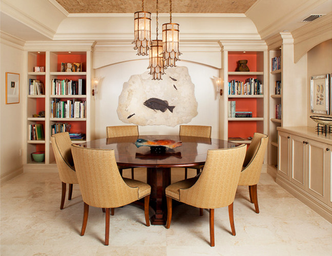 An irregularly shaped fossil stone mural with a large Phareodus encaustus, and three Knightia eocaena hangs in the science library of a home