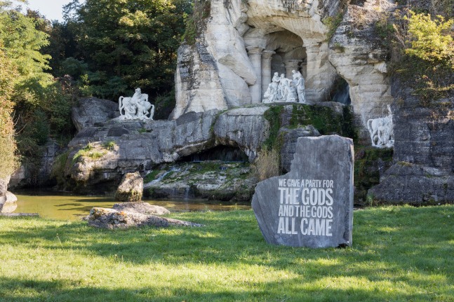 Outdoor view of stone sculpture by John Giorno, WE GAVE A PARTY FOR THE GODS 2017 Engraved limestone 190 x 150 x 80 cm / 74 3/4 x 59 x 31 1/2 in