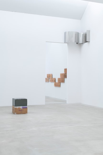 Installation view of a sculpture and wall works by Walead Beshty