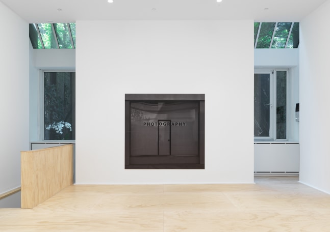 Installation view of photographs by Shannon Ebner