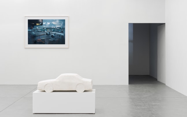 installation view of photographs of airports and car sculptures by Peter Fischli and David Weiss