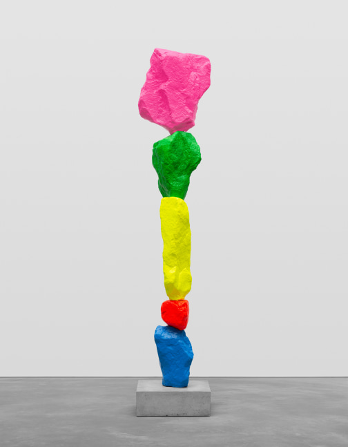 Indoor view of colorful mountain sculpture by Ugo Rondinone, blue red yellow green pink mountain 2021 Painted stone, stainless steel, pedestal Sculpture 212 x 40 x 21 cm / 83 1/2 x 15 3/4 x 8 1/4 in Pedestal 15 x 45 x 45 cm / 5 7/8 x 17 3/4 x 17 3/4 in