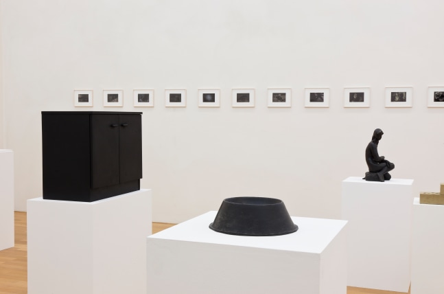 Installation view of sculptures and photographs by Peter Fischli and David Weiss