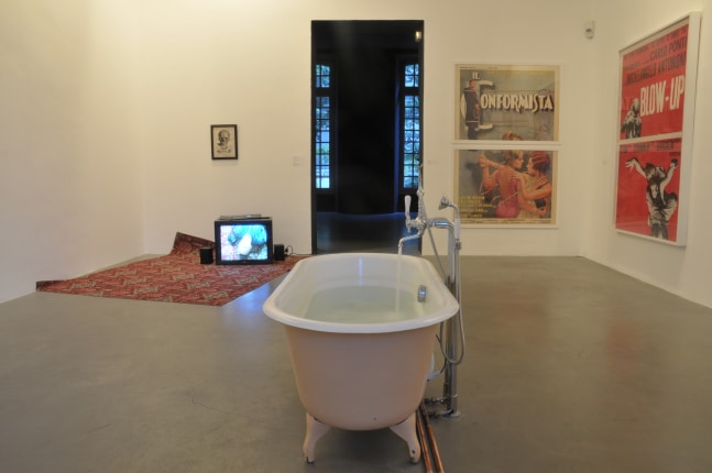 Installation view of photographs and sculptures by Douglas Gordon