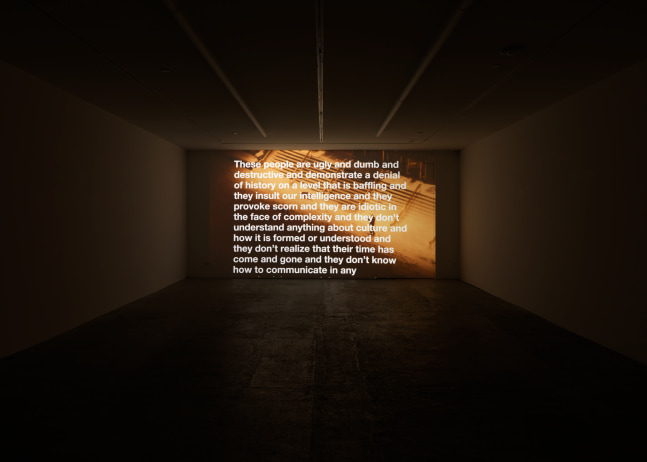 Installation view of Liam Gillick and Adam Pendleton films and wall-based works