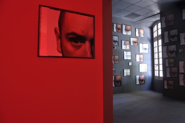 Installation view of photographs and sculptures by Douglas Gordon
