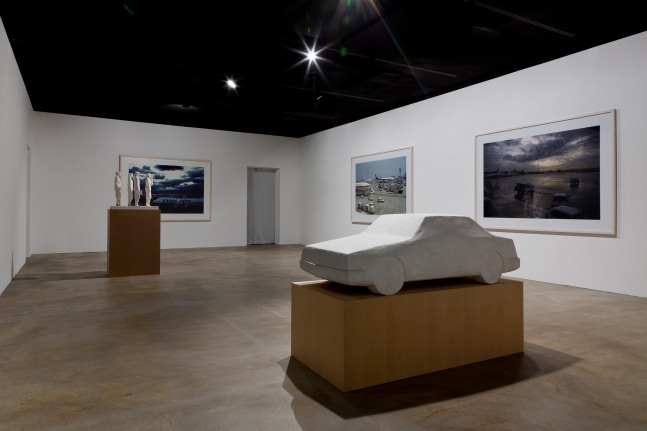 Installation view of sculptures and photographs by Peter Fischli and David Weiss