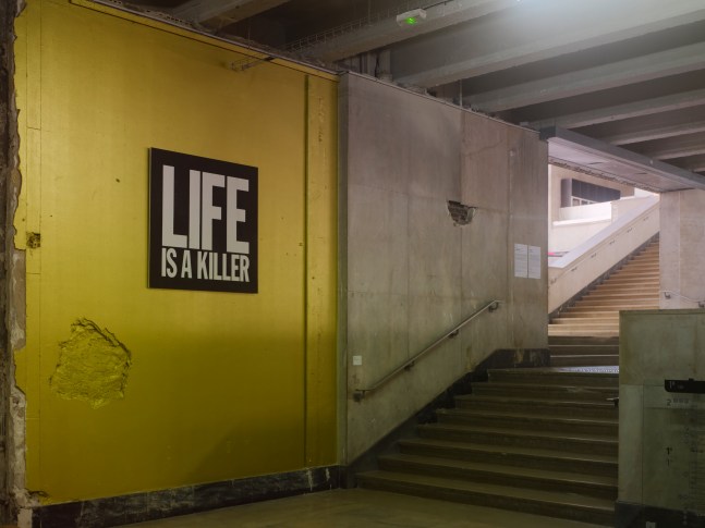 Installation view of wall work by John Giorno