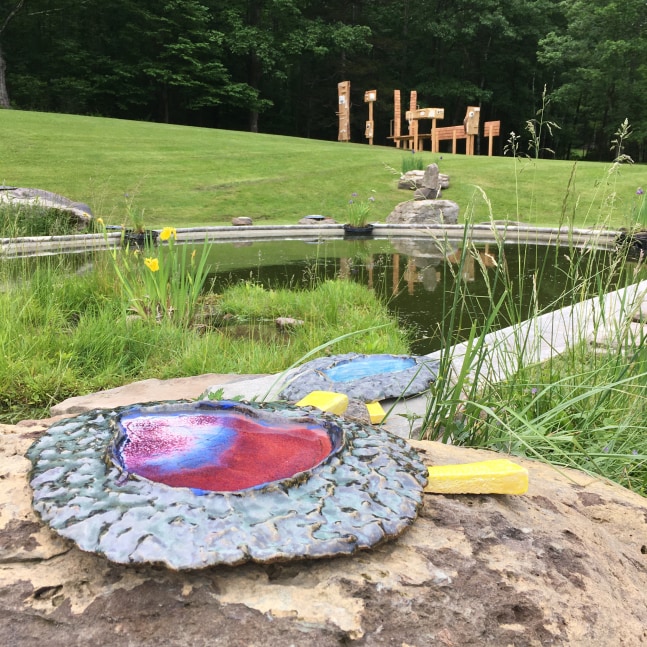 Color photograph of an outdoor ceramic sculptural installation by Pam Lins at the Al Held Foundation, 2021. Exhibition curated by Alyson Baker and River Valley Arts Collective