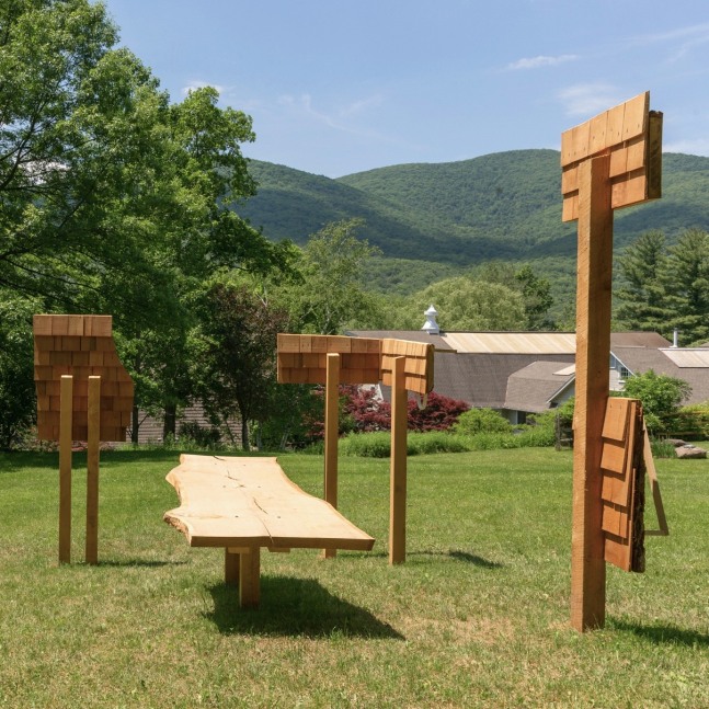 Outdoor wooden sculpture at the Al Held Foundation, made of wooden posts, planks, cedar shingles, and ceramic elements.