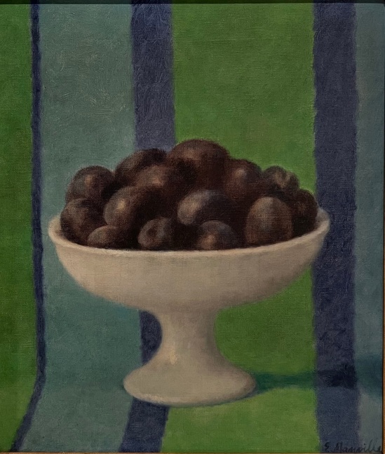 plums in a white dish against a blue and green striped backtroune