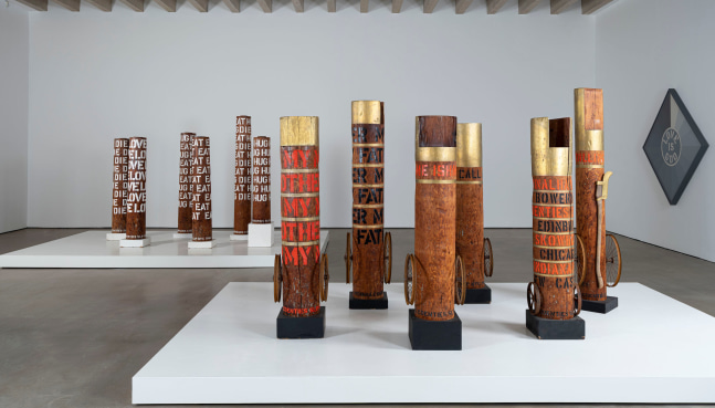 Robert Indiana: Sculpture 1958-2018 installation view at Yorkshire Sculpture Park. Pictured are twelve columns and the grisaille painting Love Is God