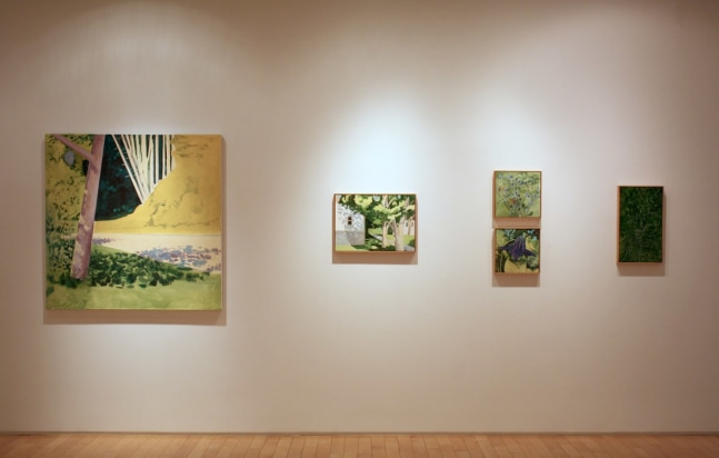 Photograph showing a view of an exhibition space, with five paintings hanging on a white wall