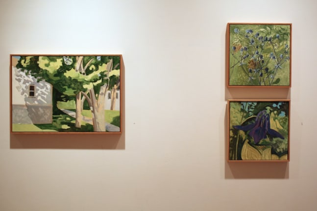 Photograph showing a view of an exhibition, with three small framed paintings hanging on a white wall